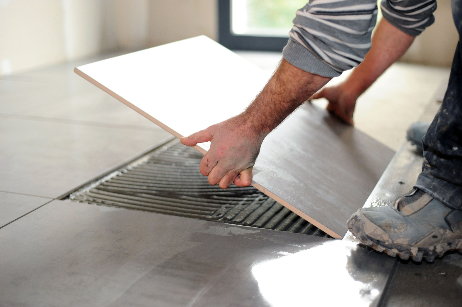 man laying tile